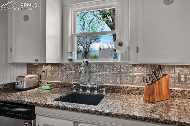 a kitchen with a sink and potted plant