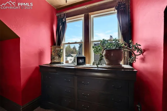 a bedroom with a bed dresser and a flat screen tv