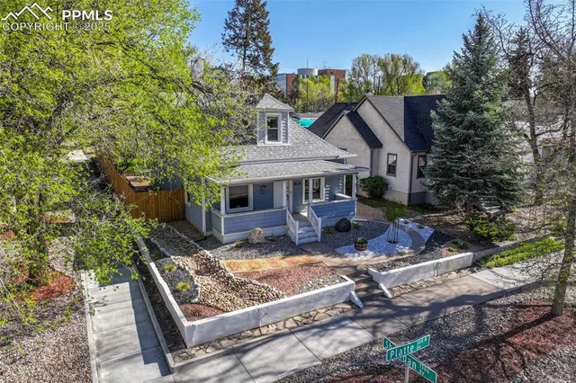 a view of house with backyard outdoor seating and green space