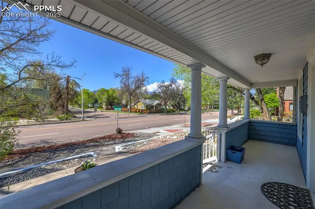 a view of a patio with a table and chairs next to a yard