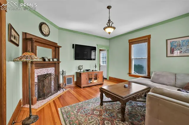 a living room with furniture a flat screen tv and a fireplace
