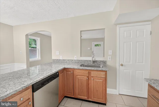 a bathroom with a granite countertop sink a mirror and vanity