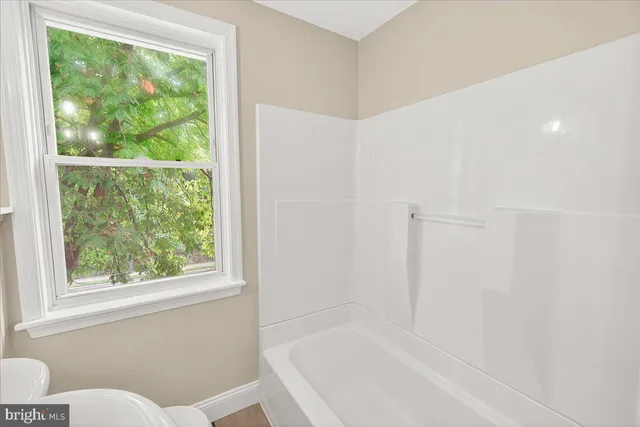 a bathroom with a bathtub and window