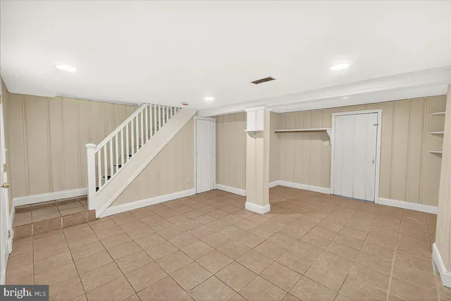 a view of an empty room with stairs