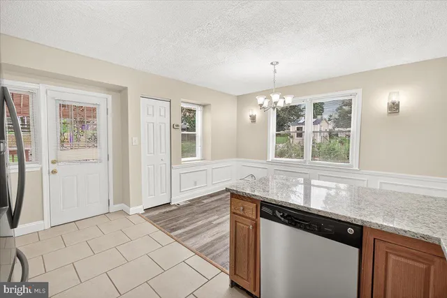 a kitchen with granite countertop a sink cabinets and window