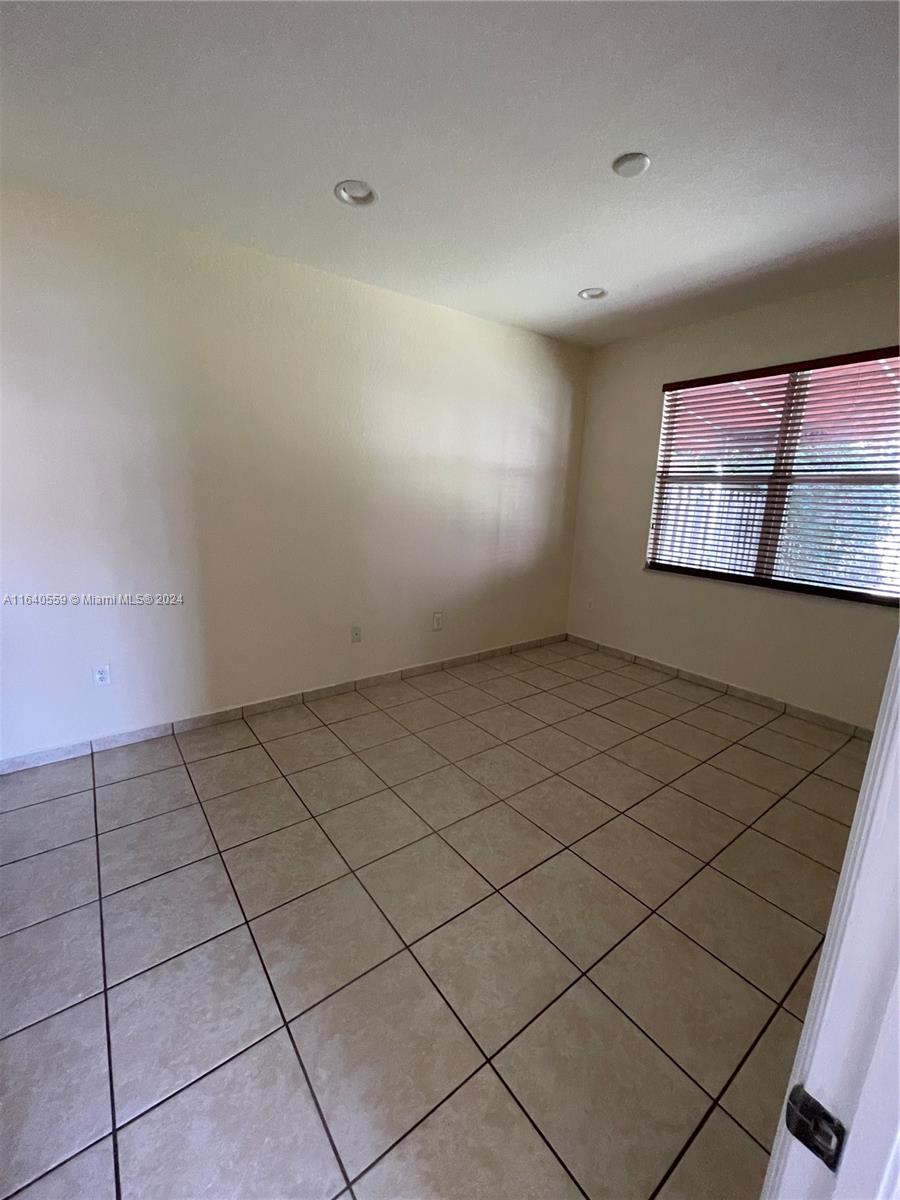 23852 Southwest 109th Place Homestead, FL 33032 - Photo 11 of 19 a view of an empty room and window