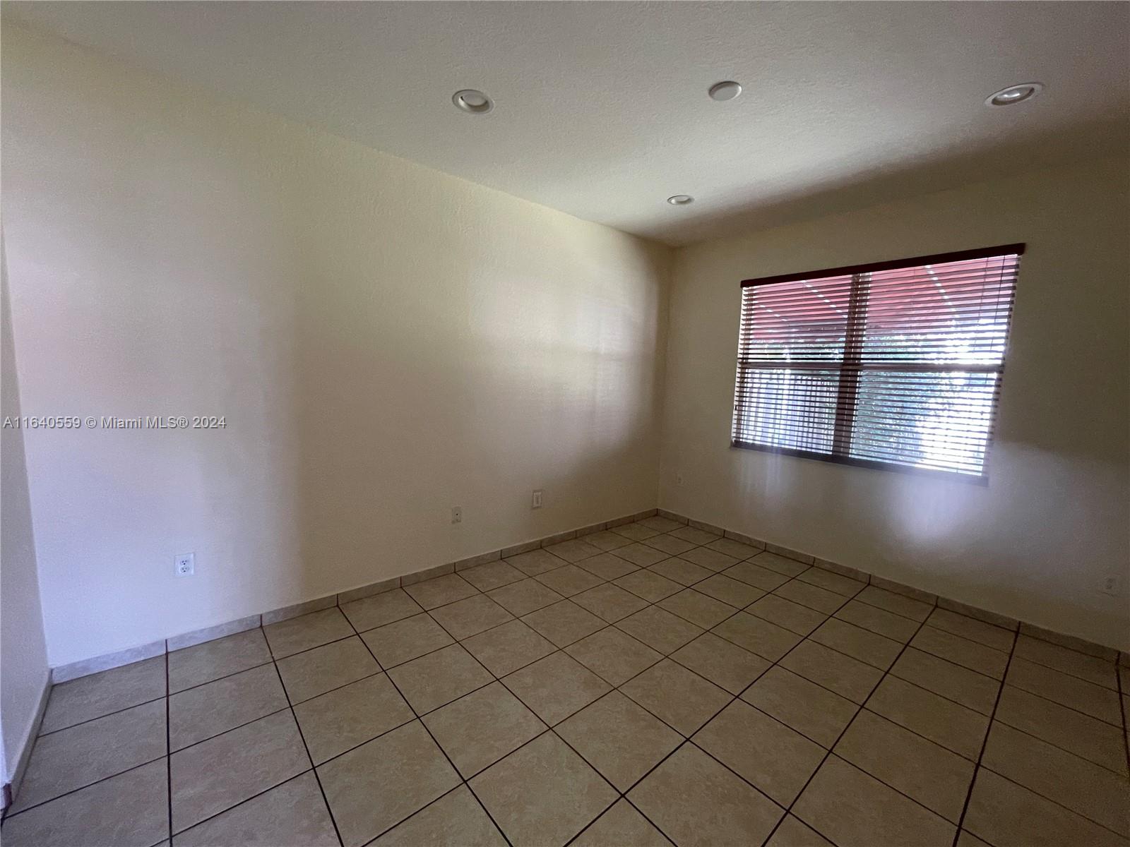 23852 Southwest 109th Place Homestead, FL 33032 - Photo 12 of 19 a view of an empty room and window