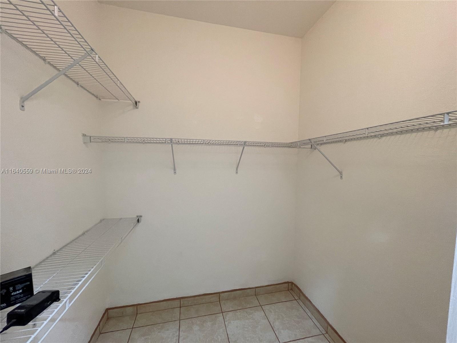 23852 Southwest 109th Place Homestead, FL 33032 - Photo 15 of 19 a view of a room with racks on the wall