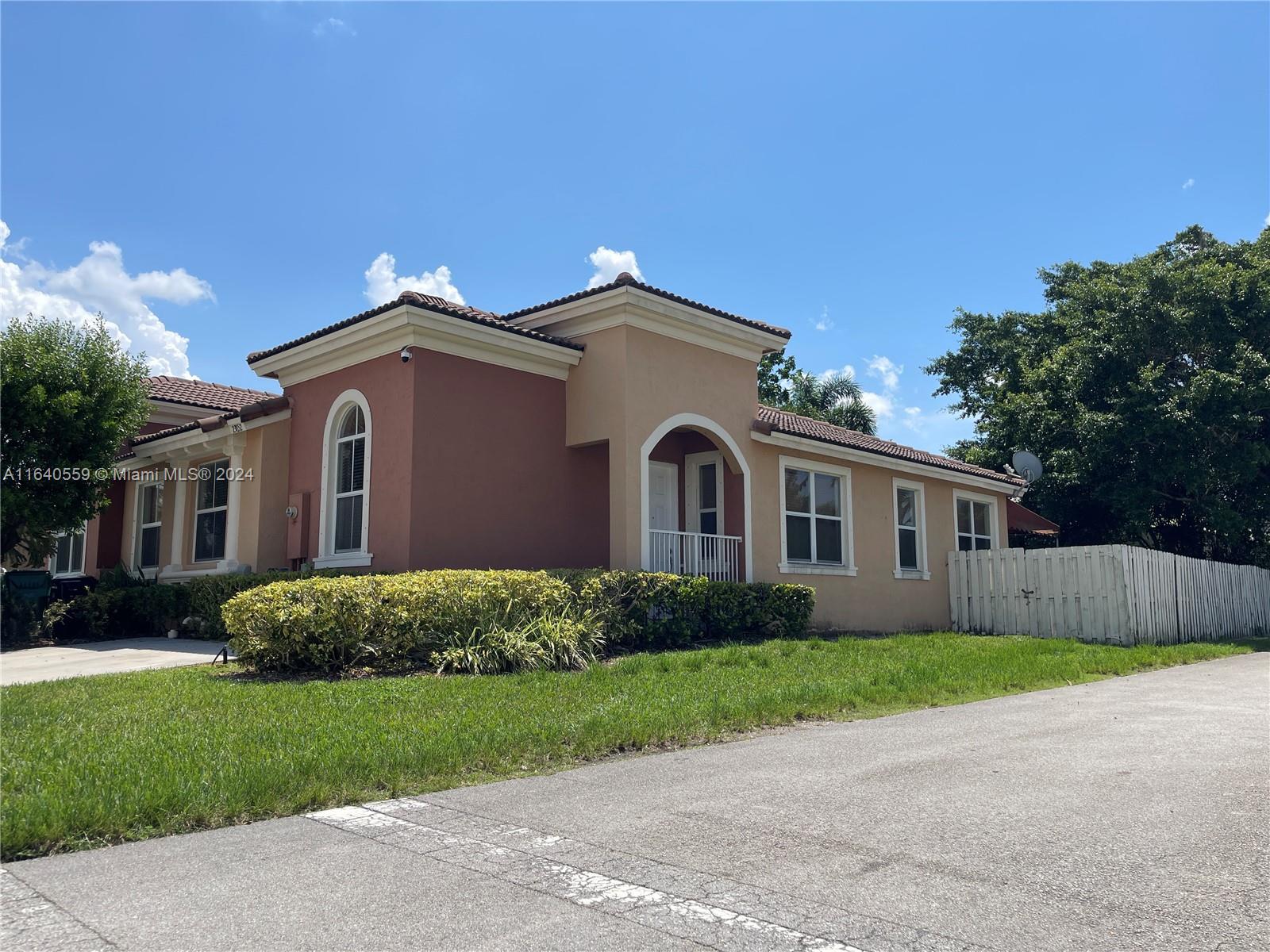 23852 Southwest 109th Place Homestead, FL 33032 - Photo 2 of 19 a front view of a house with a garden