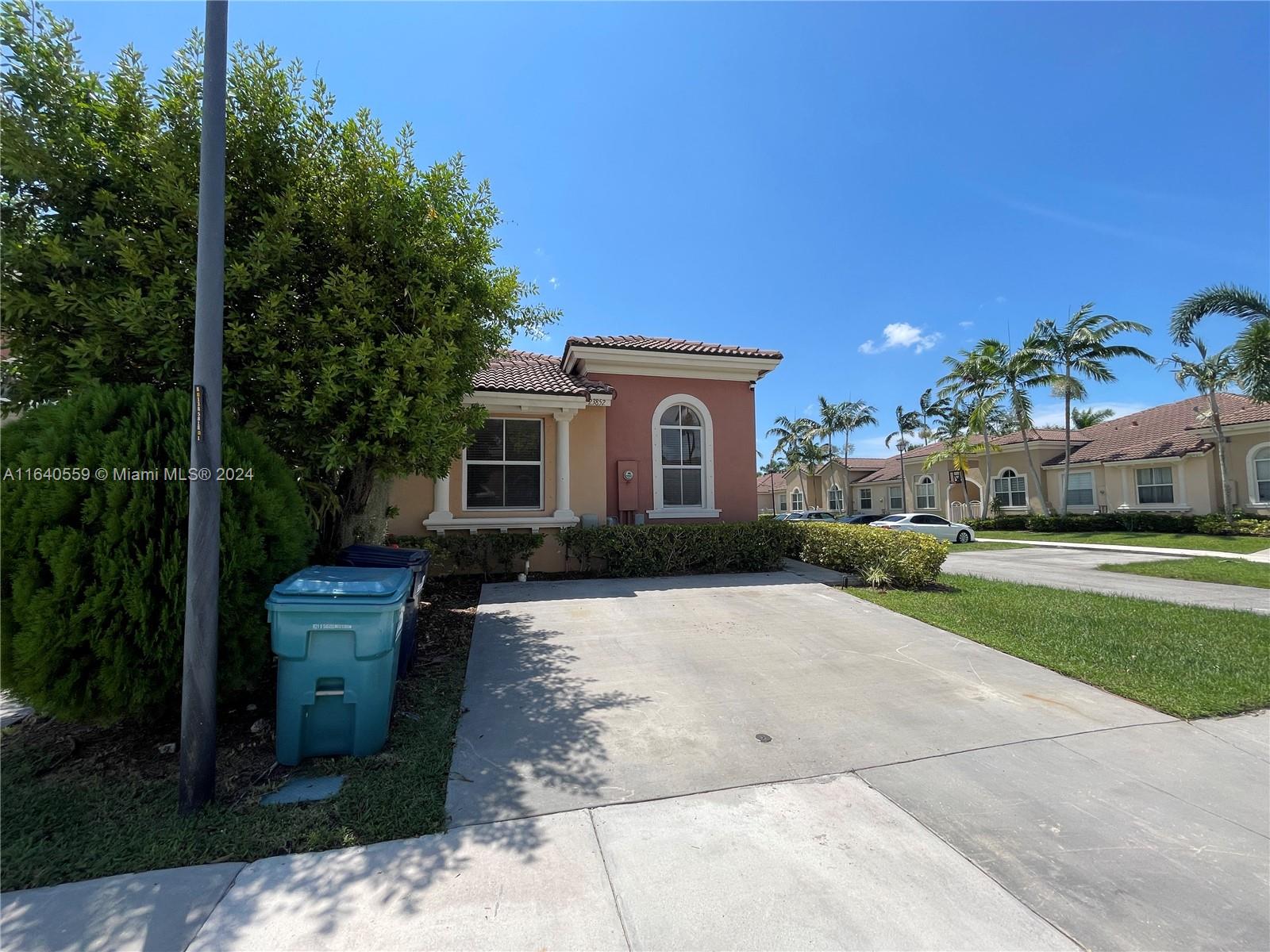 23852 Southwest 109th Place Homestead, FL 33032 - Photo 3 of 19 a front view of a house with a yard