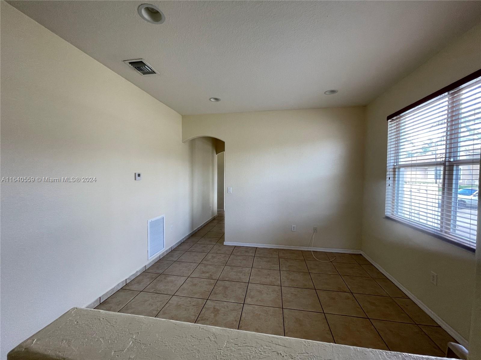 23852 Southwest 109th Place Homestead, FL 33032 - Photo 4 of 19 an empty room with a empty space and windows