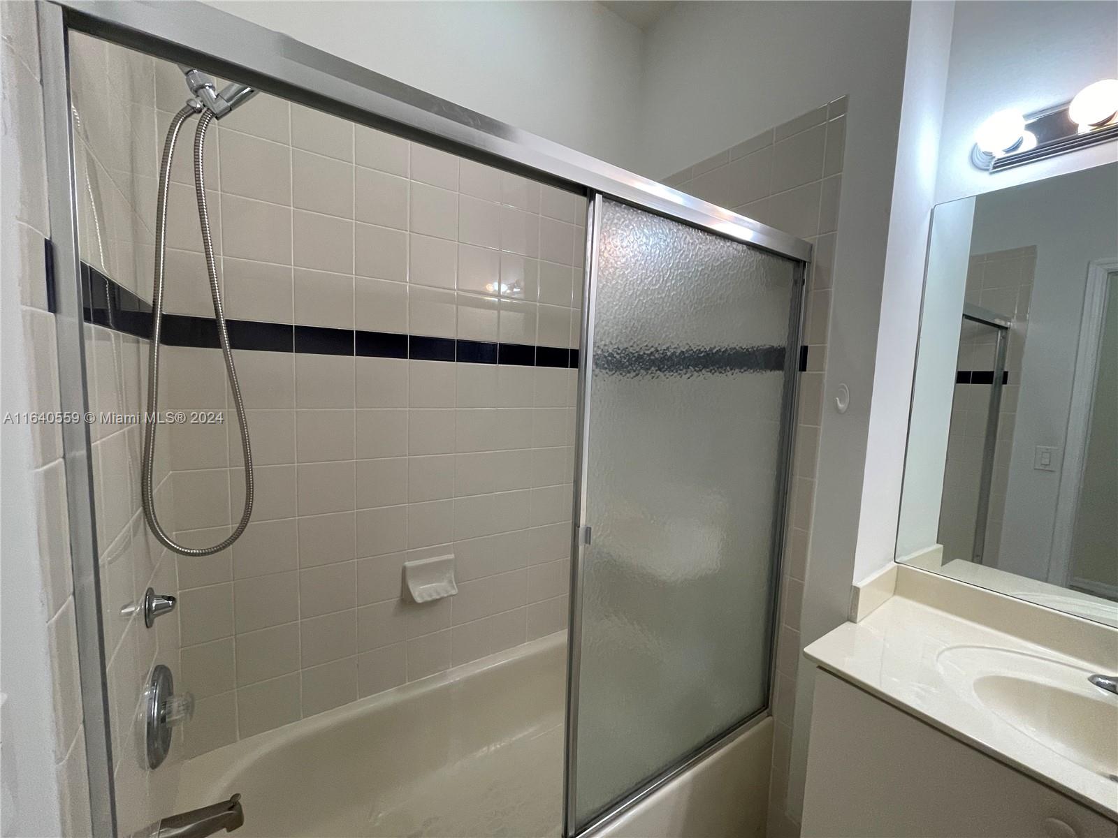 23852 Southwest 109th Place Homestead, FL 33032 - Photo 8 of 19 a bathroom with a shower and a sink