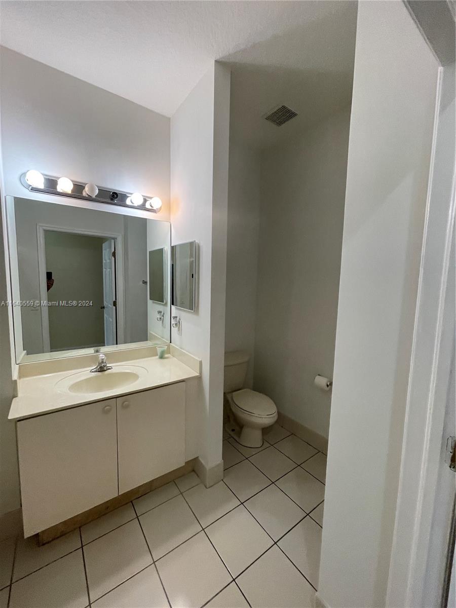 23852 Southwest 109th Place Homestead, FL 33032 - Photo 9 of 19 a bathroom with a sink a toilet and shower