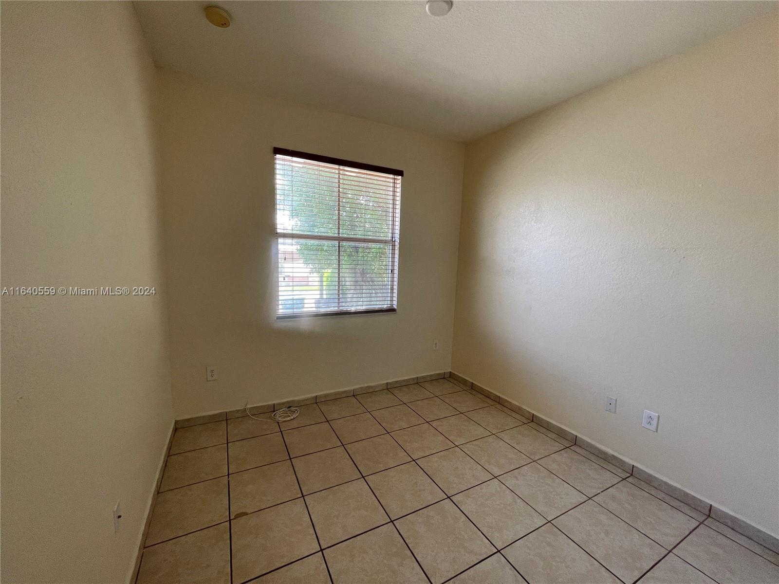23852 Southwest 109th Place Homestead, FL 33032 - Photo 10 of 19 an empty room with windows