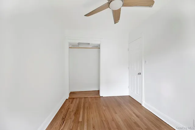 a view of a room with wooden floor and white walls