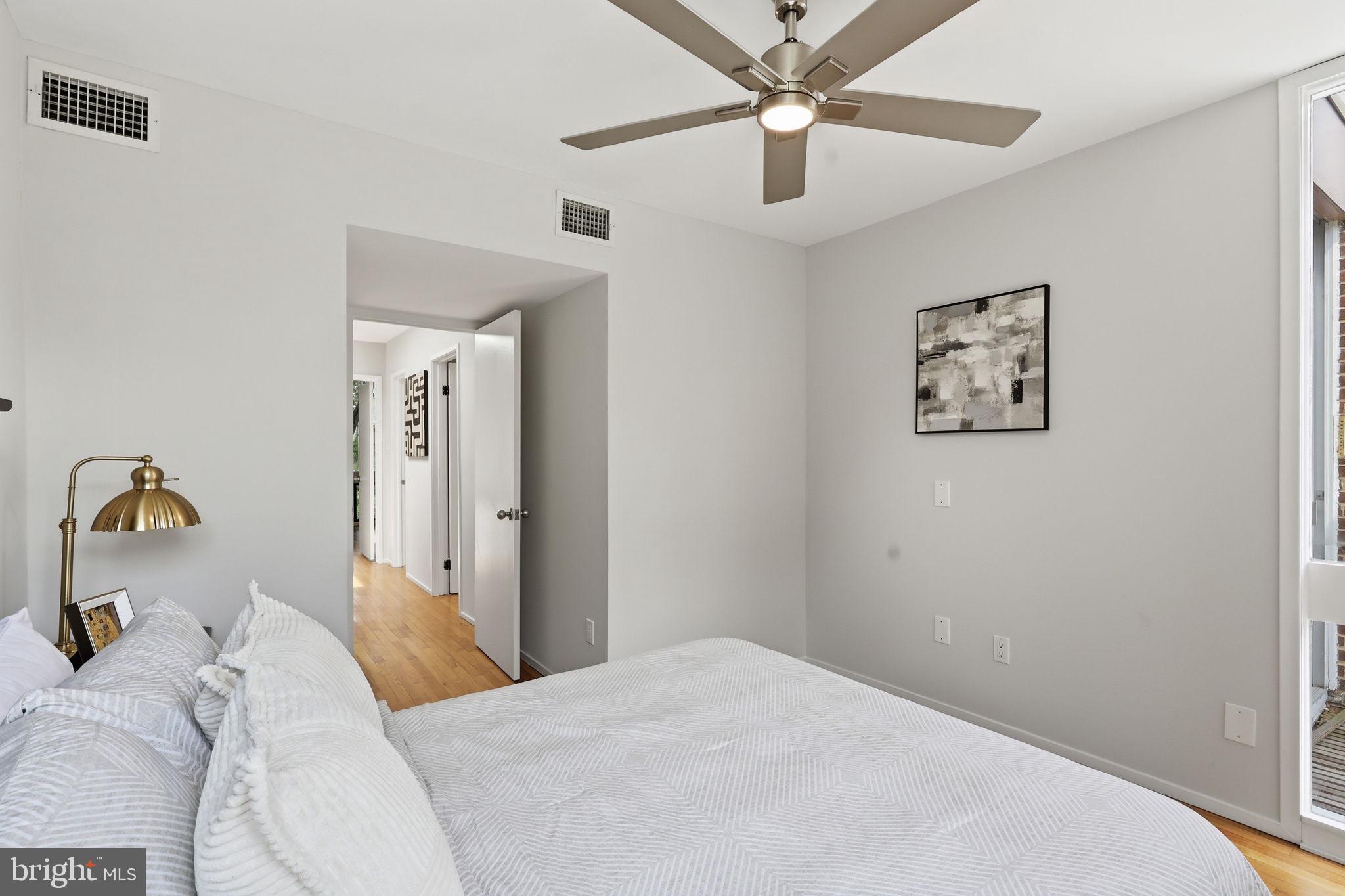 11510 Maple Ridge Road Reston, VA 20190 - Photo 25 of 43 a bedroom with a large bed and a chandelier