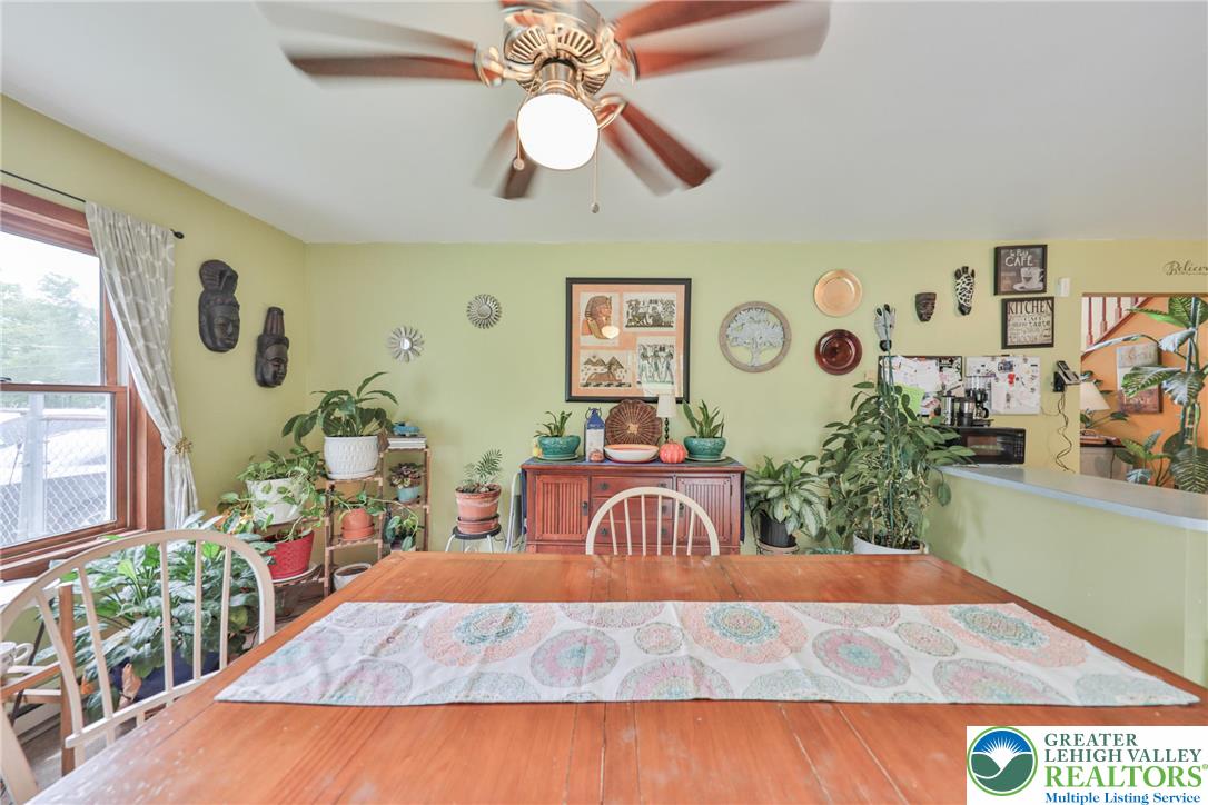 4608 Pine Ridge Drive West Bushkill, PA 18324 - Photo 17 of 62 A classic ceiling fan provides comfort in this well-lit dining area, perfect for daily meals.