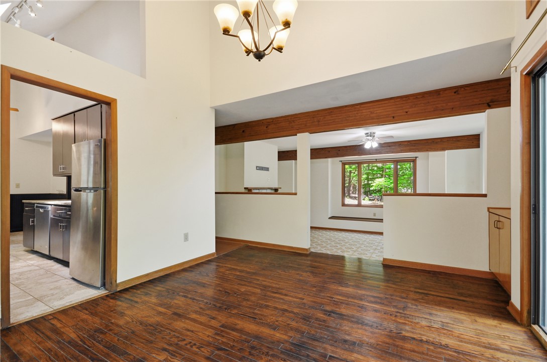 1298 Carradine Road Seneca, SC 29678 - Photo 20 of 43 Rich hardwood flooring anchors an airy dining area, leading into a bright kitchen.