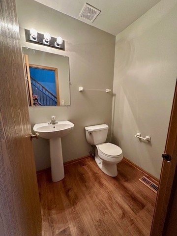 2446 Oak Tree Lane, Unit 2446 Plainfield, IL 60586 - Photo 11 of 11 a white toilet sitting next to a bathroom sink