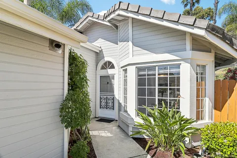 a front view of a house with a garden