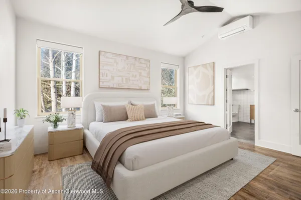 a bedroom with a large bed and a couch