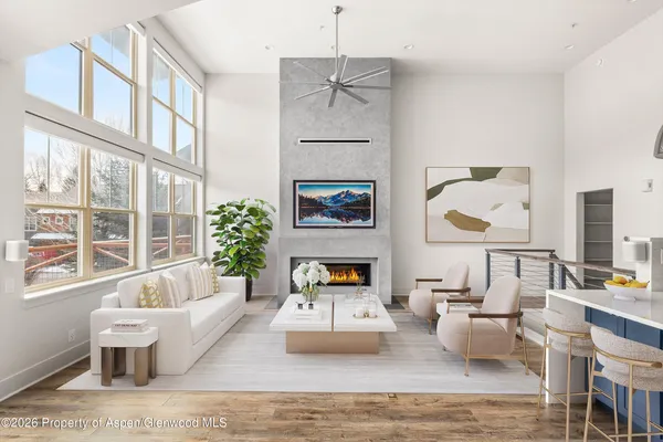 a living room with fireplace furniture and a large window
