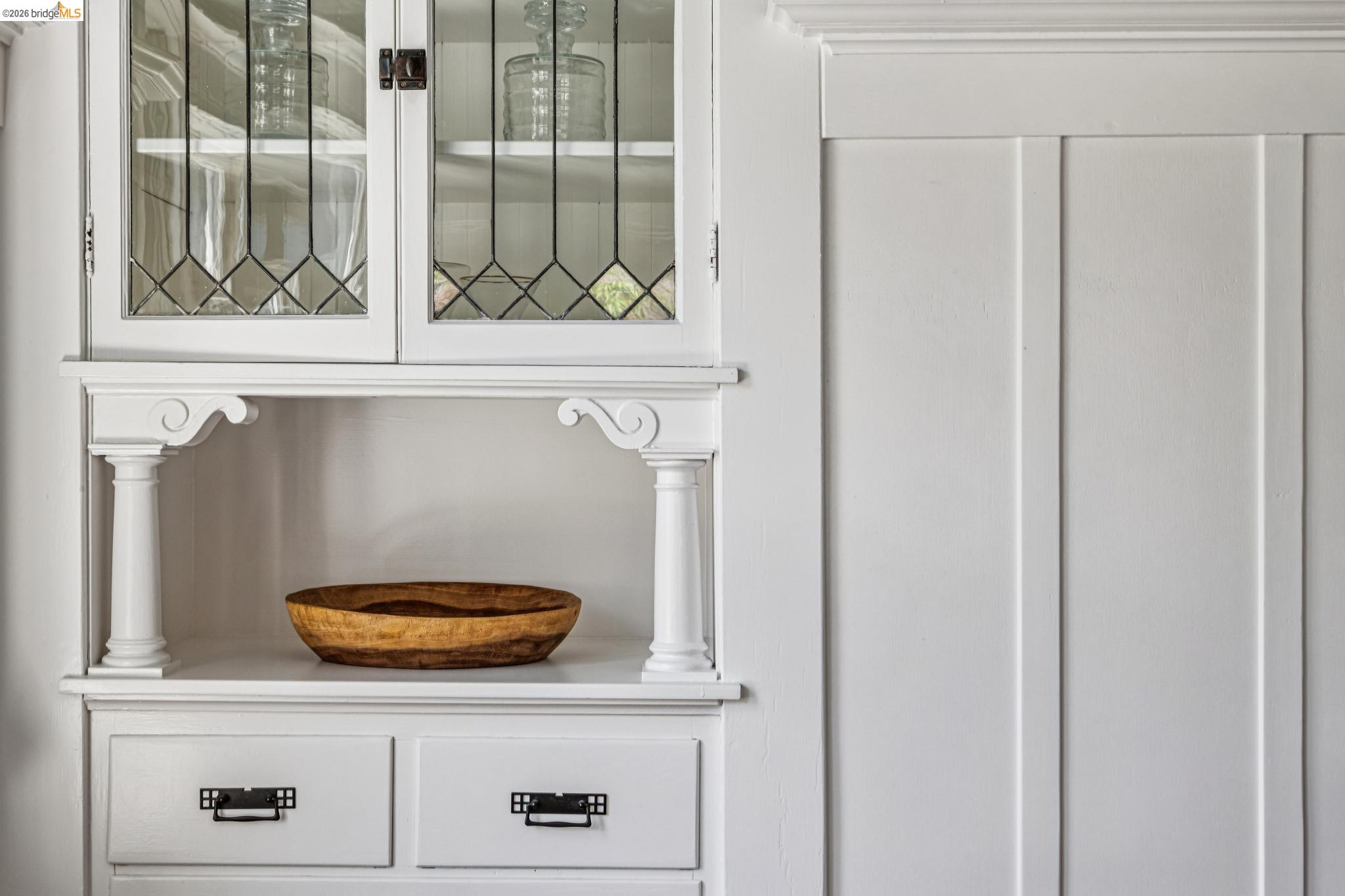 6521 Dover Street Berkeley, CA 94703 - Photo 19 of 80 Built-in cabinetry with leaded glass uppers, open shelving, and lower drawers featuring decorative hardware
