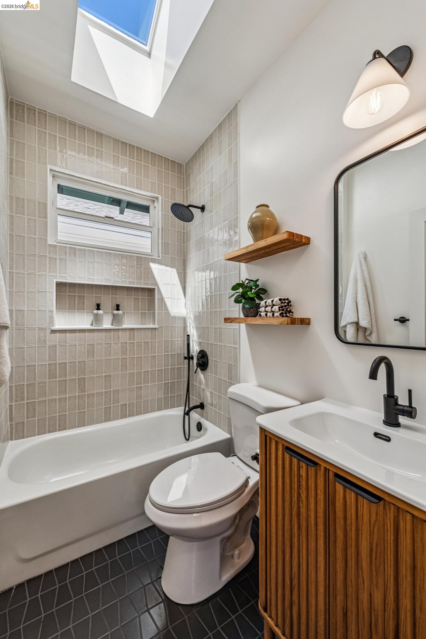 6521 Dover Street Berkeley, CA 94703 - Photo 26 of 80 Bathroom with a built-in tub and shower featuring matte black fixtures, light-toned mosaic wall tiles, and a recessed shower niche