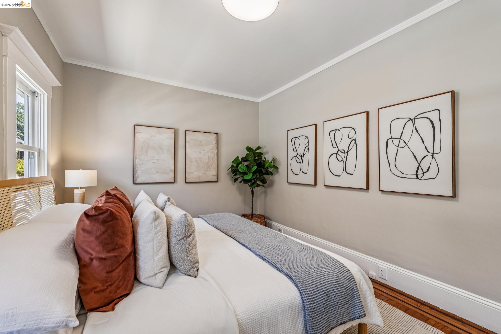 6521 Dover Street Berkeley, CA 94703 - Photo 29 of 80 Room with wood-finish flooring, a window with white trim, and a white ceiling light fixture