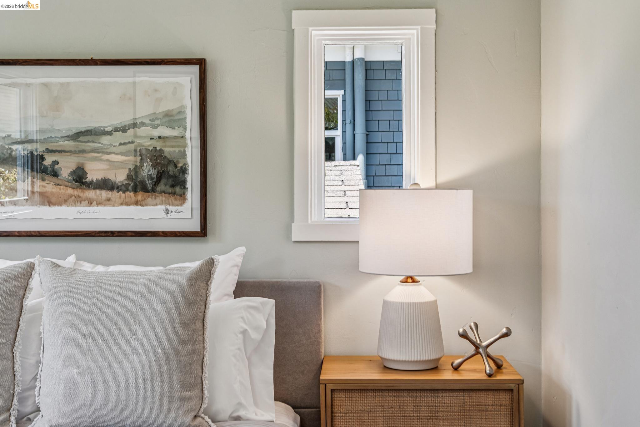 6521 Dover Street Berkeley, CA 94703 - Photo 33 of 80 Bedroom featuring a light gray wall, white-trimmed window, and a wooden nightstand with wicker-front drawers