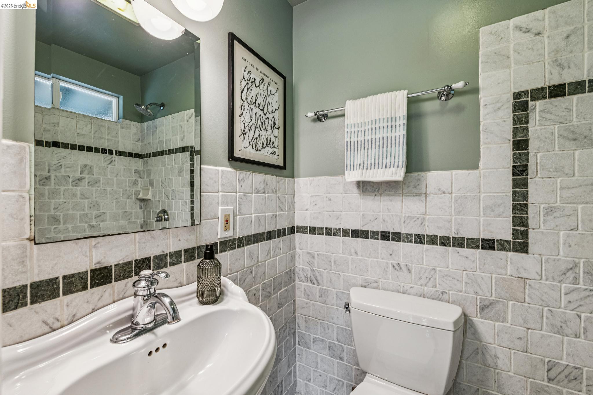 6521 Dover Street Berkeley, CA 94703 - Photo 43 of 80 Pedestal sink with chrome faucet, framed mirror, and integrated vanity lighting