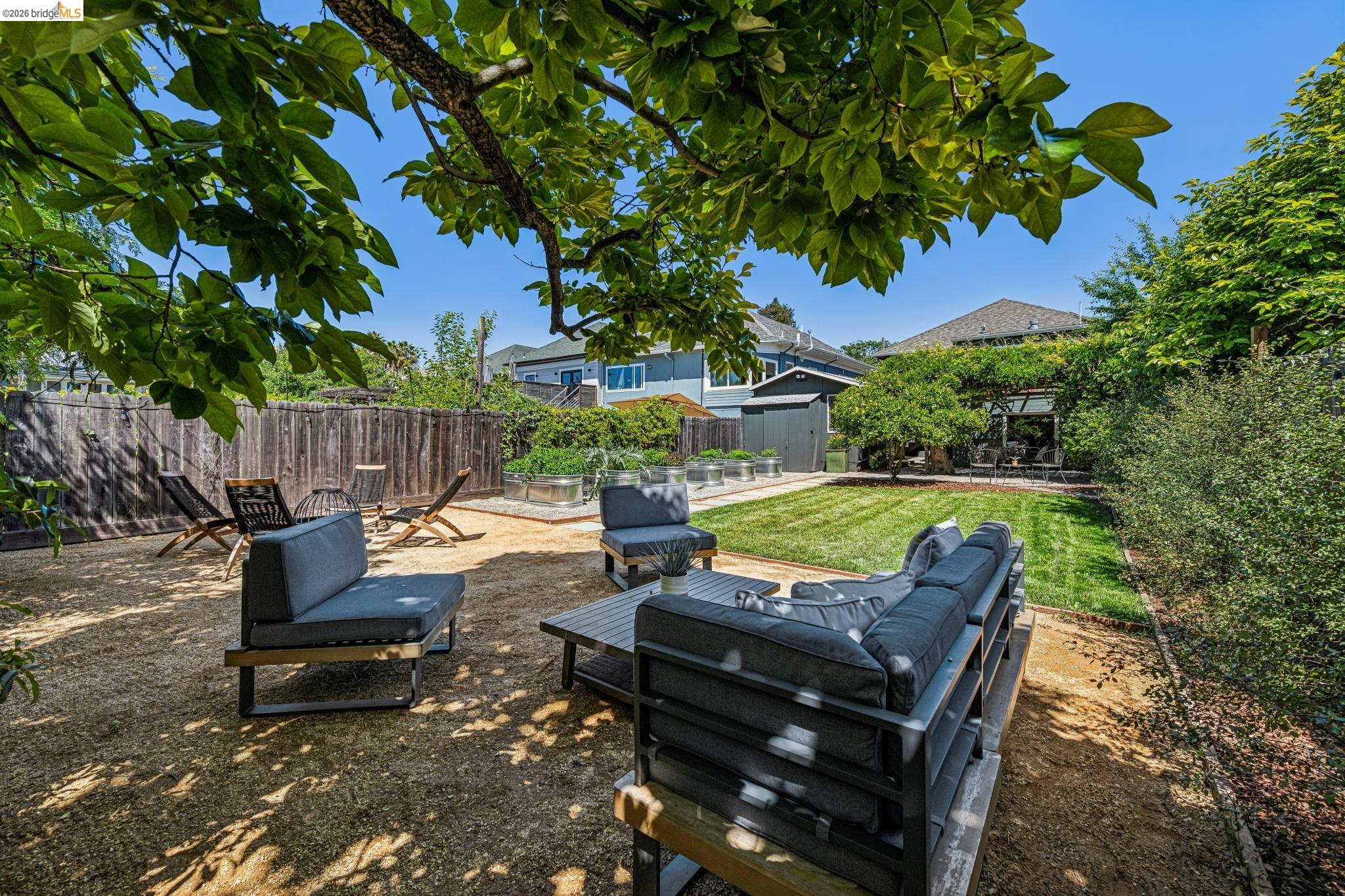 6521 Dover Street Berkeley, CA 94703 - Photo 55 of 80 Spacious backyard featuring a manicured lawn, established perimeter landscaping, and a gravel patio area