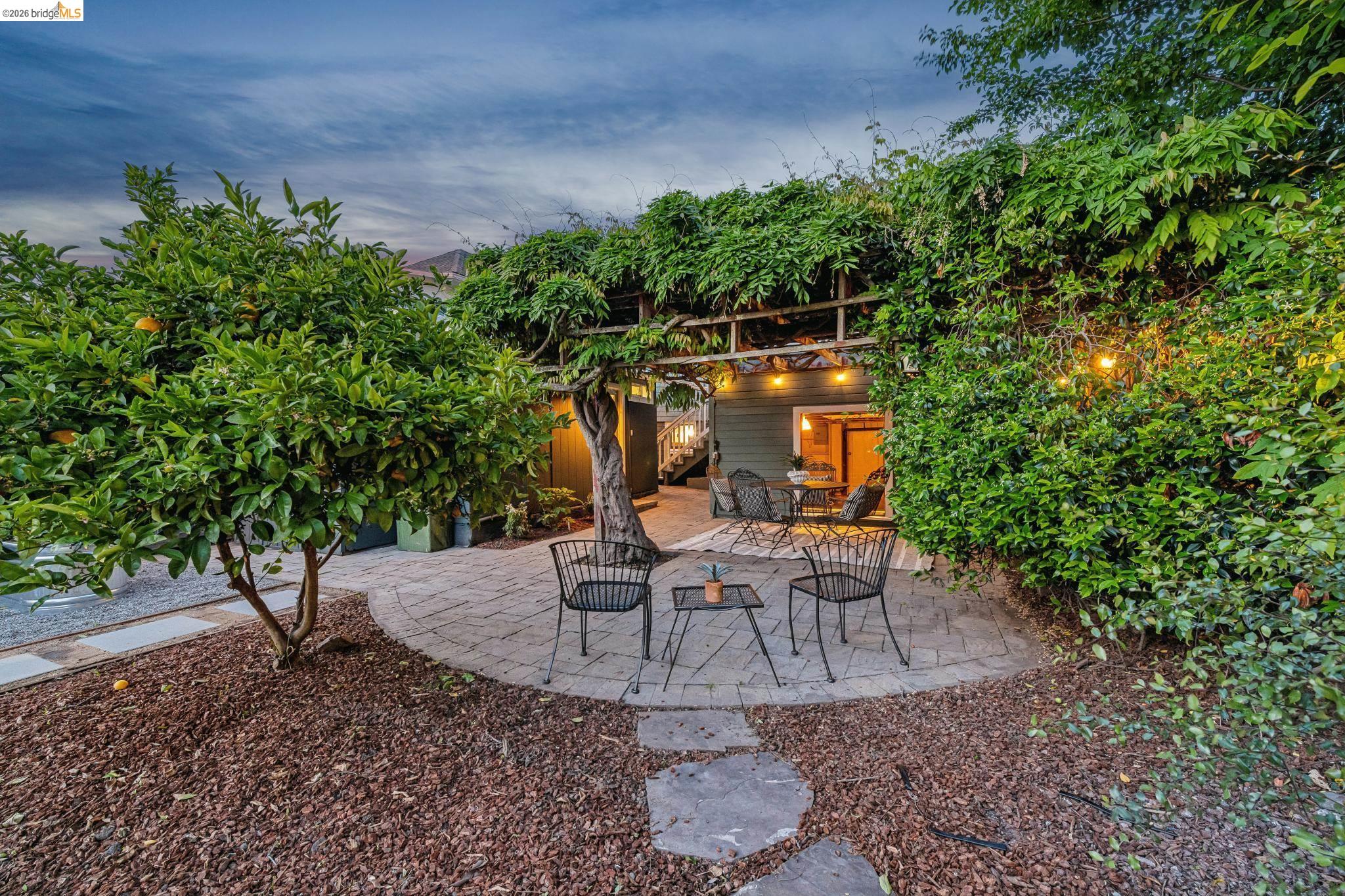 6521 Dover Street Berkeley, CA 94703 - Photo 73 of 80 Outdoor patio featuring a circular stone paver area, surrounded by dark ground cover