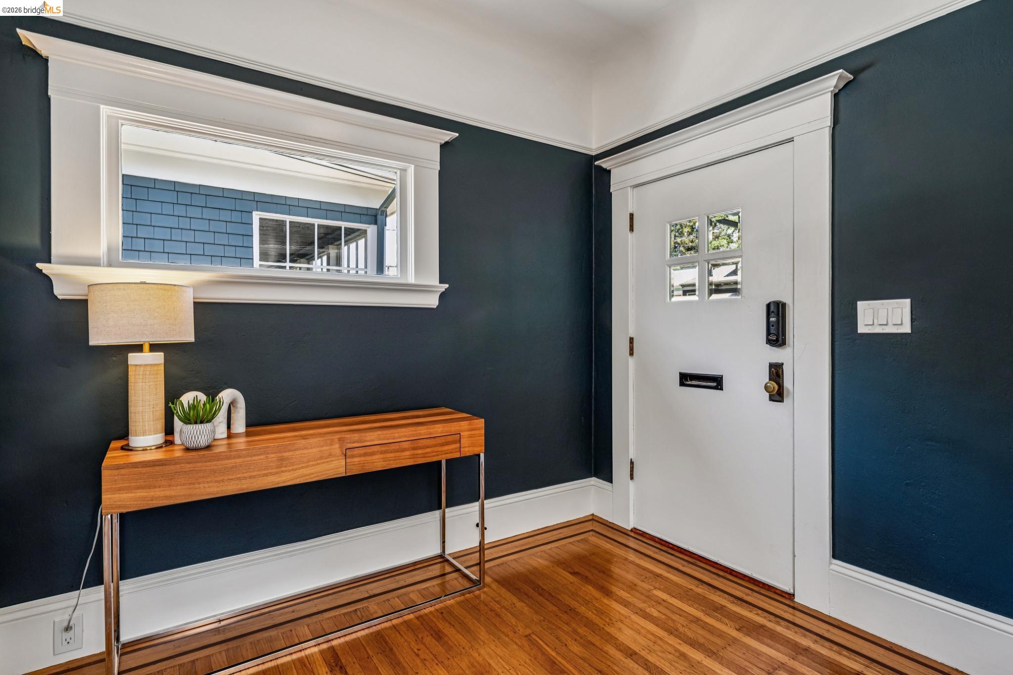 6521 Dover Street Berkeley, CA 94703 - Photo 8 of 80 Entryway featuring rich wood-finish flooring, white baseboards, and a solid white door with divided lites and an electronic lockset