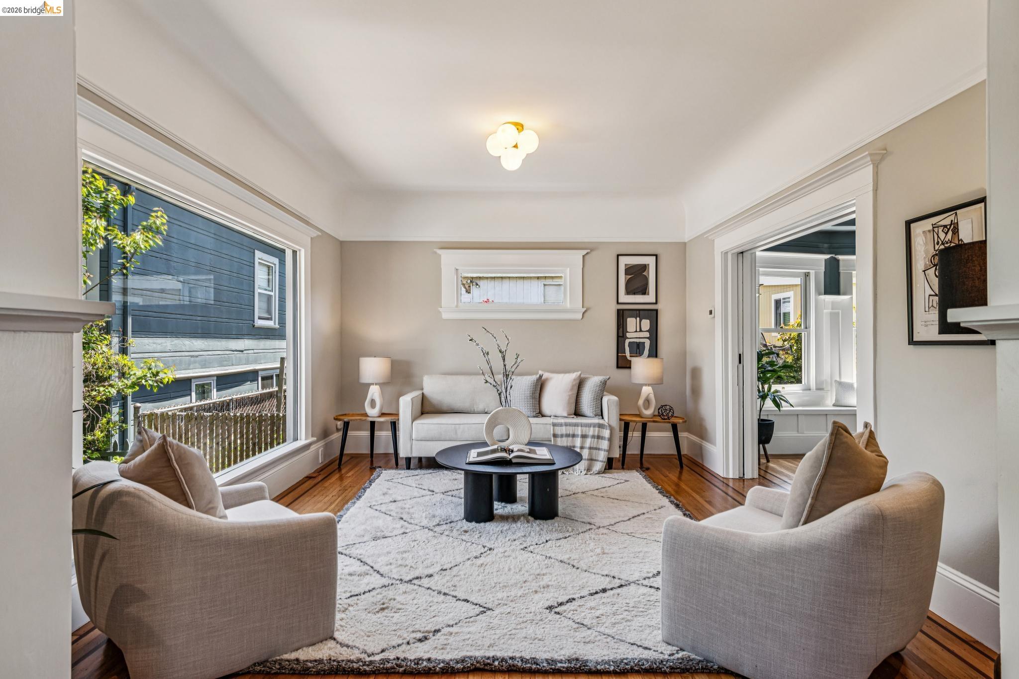 6521 Dover Street Berkeley, CA 94703 - Photo 10 of 80 Bright living space featuring warm wood-finish flooring, a decorative ceiling fixture, and ample natural light from large windows