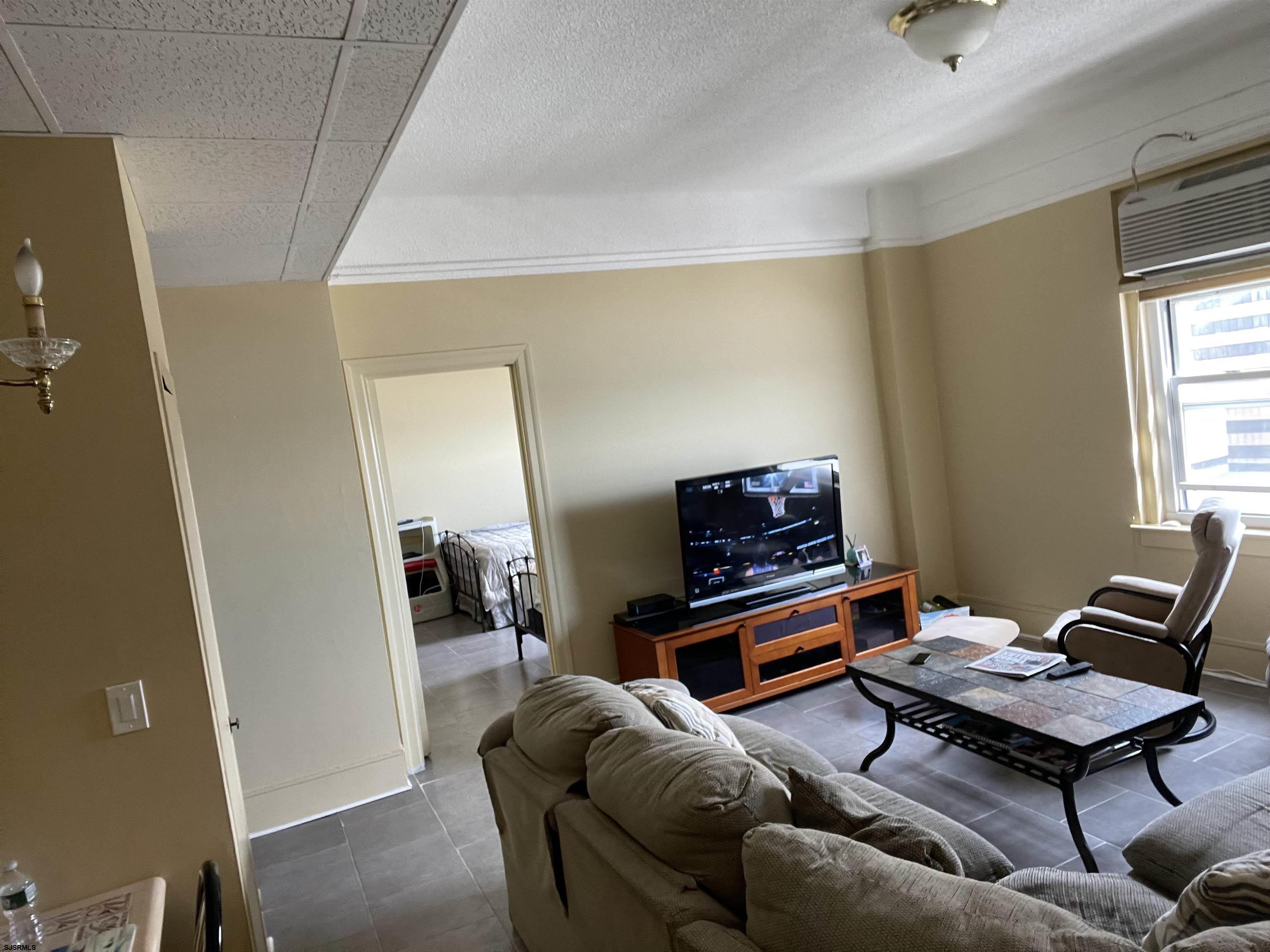 2715 Boardwalk, Unit 1209 Atlantic City, NJ 08401 - Photo 13 of 57 a living room with furniture and a window