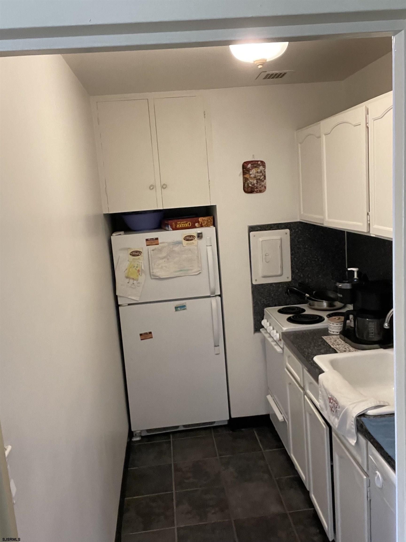 2715 Boardwalk, Unit 1209 Atlantic City, NJ 08401 - Photo 15 of 57 a kitchen with a stove and a refrigerator