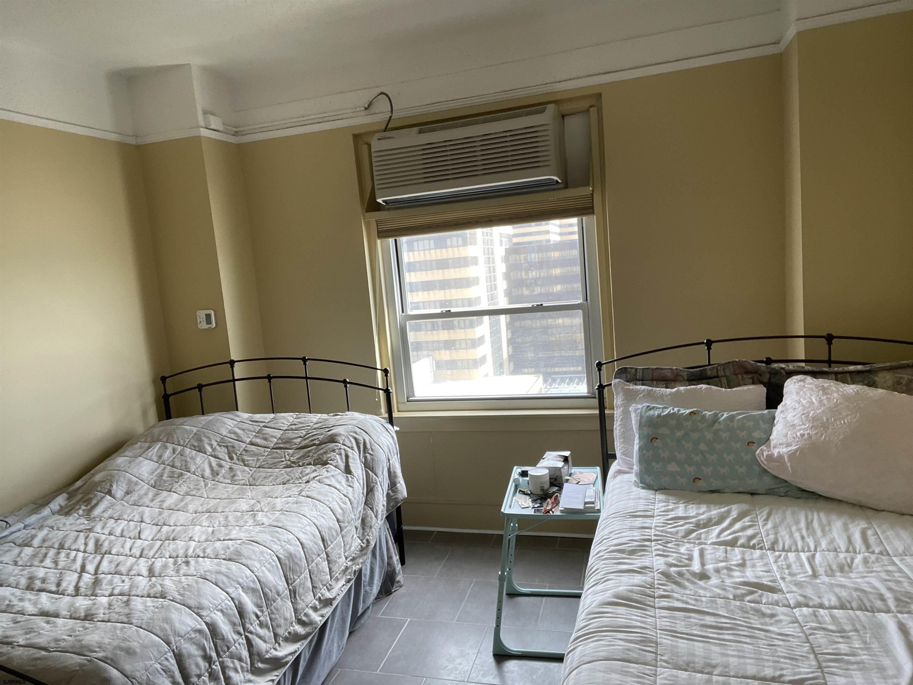 2715 Boardwalk, Unit 1209 Atlantic City, NJ 08401 - Photo 17 of 57 a bedroom with a bed and a window