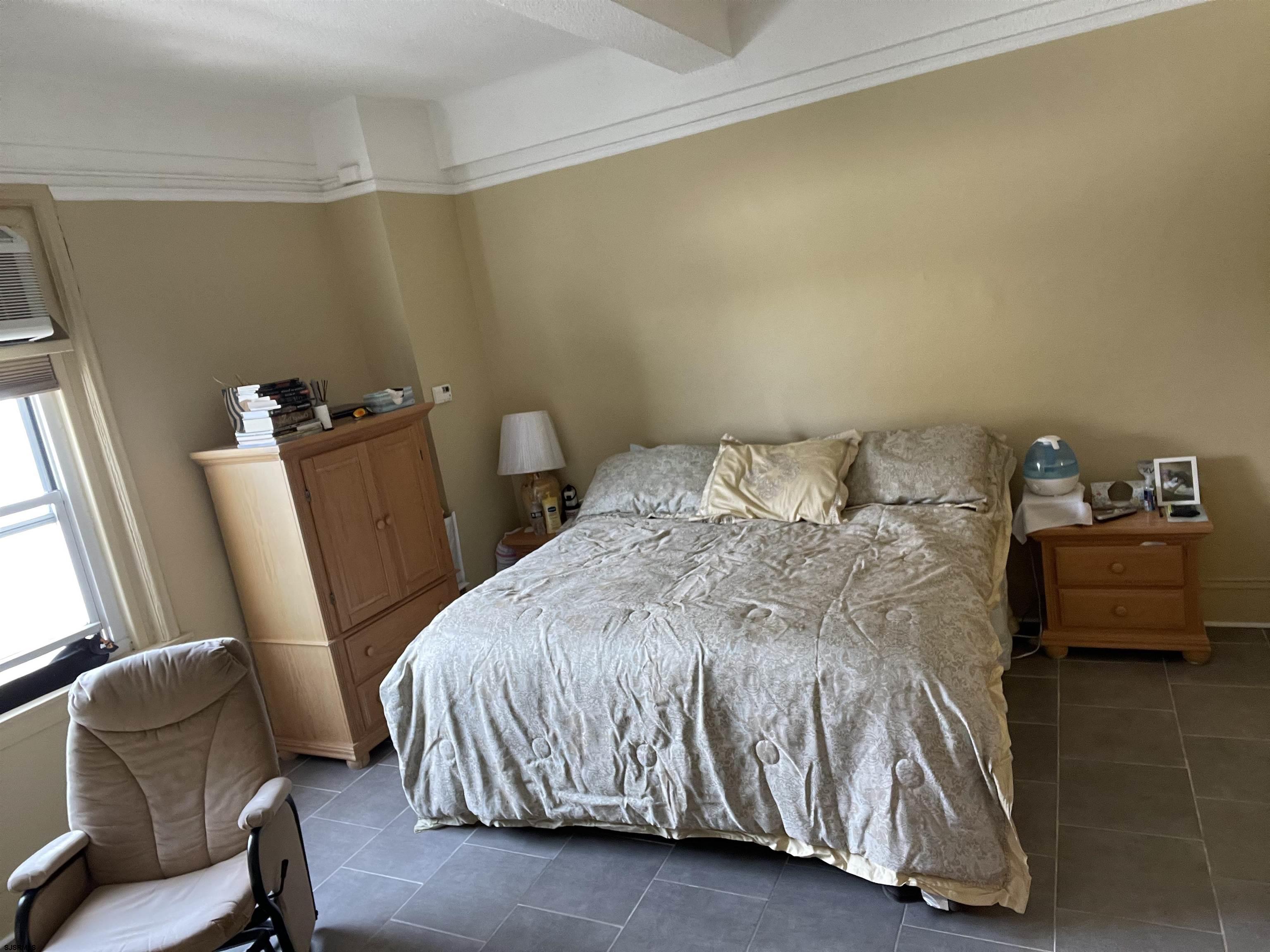 2715 Boardwalk, Unit 1209 Atlantic City, NJ 08401 - Photo 3 of 57 a bedroom with a bed and a chair