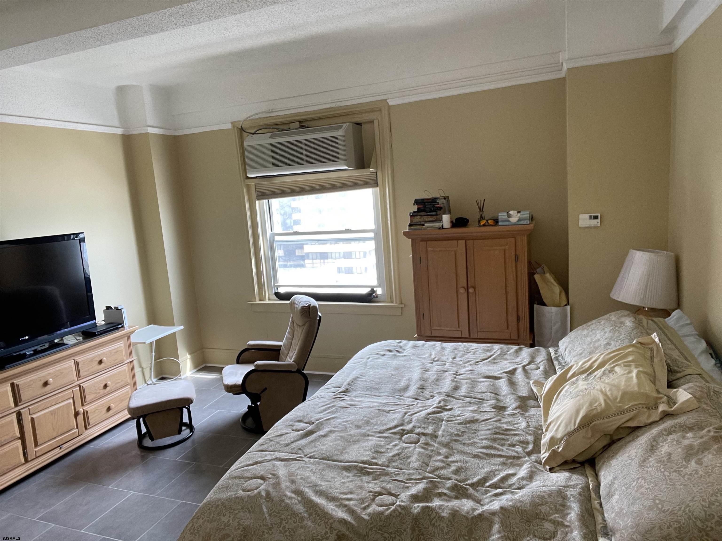 2715 Boardwalk, Unit 1209 Atlantic City, NJ 08401 - Photo 4 of 57 a bedroom with a bed and a flat tv screen on the dresser