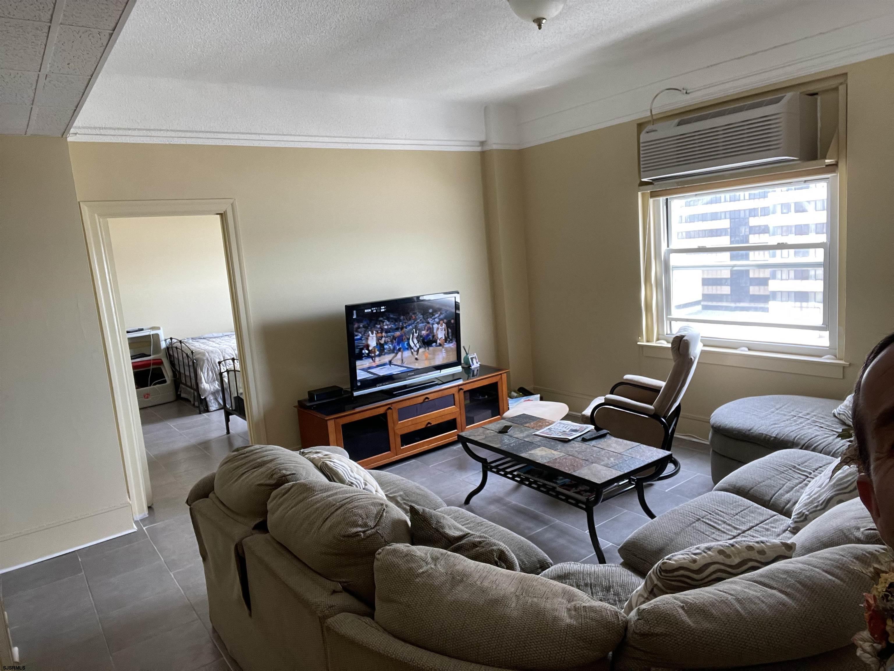 2715 Boardwalk, Unit 1209 Atlantic City, NJ 08401 - Photo 10 of 57 a living room with furniture a rug and a window