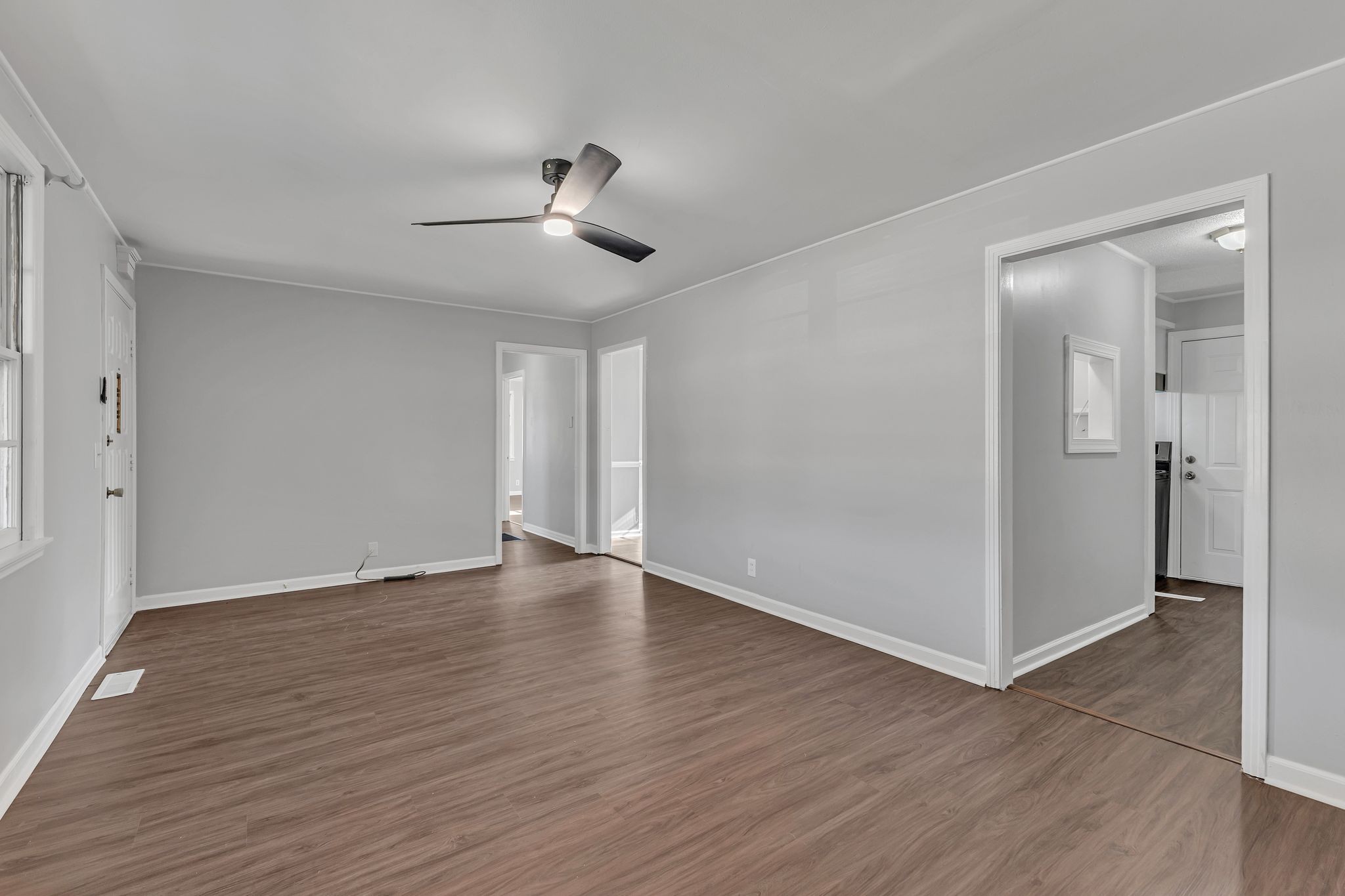 845 Richards Road Antioch, TN 37013 - Photo 6 of 24 a view of an empty room with wooden floor and a ceiling fan