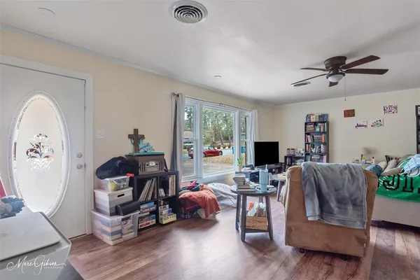 a living room with furniture and a flat screen tv