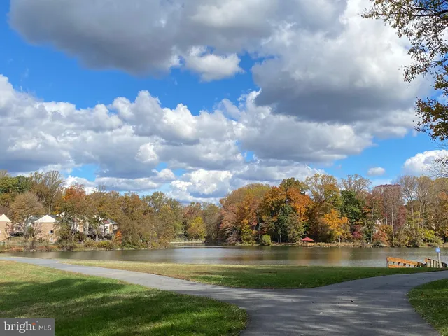 a view of building with lake and trees in the background