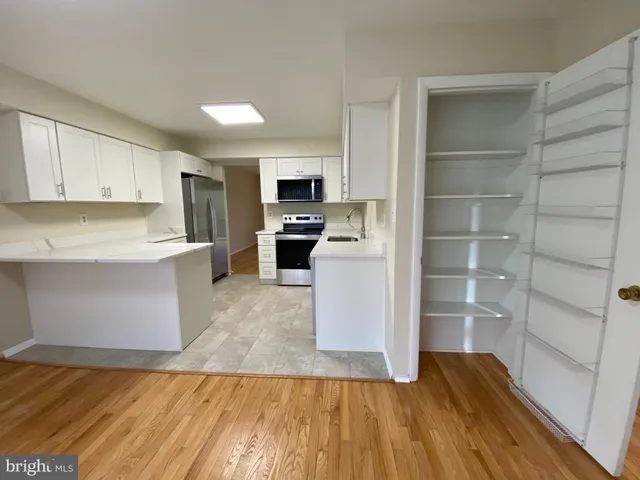 a kitchen with a refrigerator and cabinets