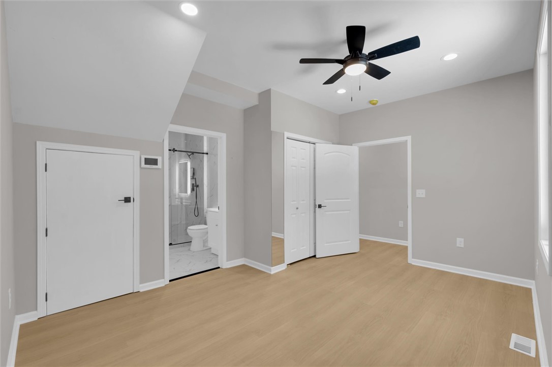 159 Cherokee Trail Easley, SC 29640 - Photo 21 of 38 A naturally illuminated bedroom offers light wood flooring, a ceiling fan, and convenient bathroom access.