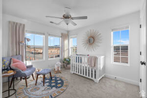 907 West Bright Ridge Ln Street, Unit 1430 St. George, UT 84790 - Photo 12 of 19 Bright room featuring a ceiling fan, white trim, and multiple windows
