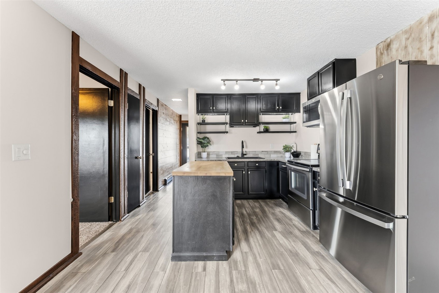 7124 Ryan Gulch Road, Unit 204 Wildernest, CO 80498 - Photo 18 of 36 a kitchen with stainless steel appliances a refrigerator and a stove top oven