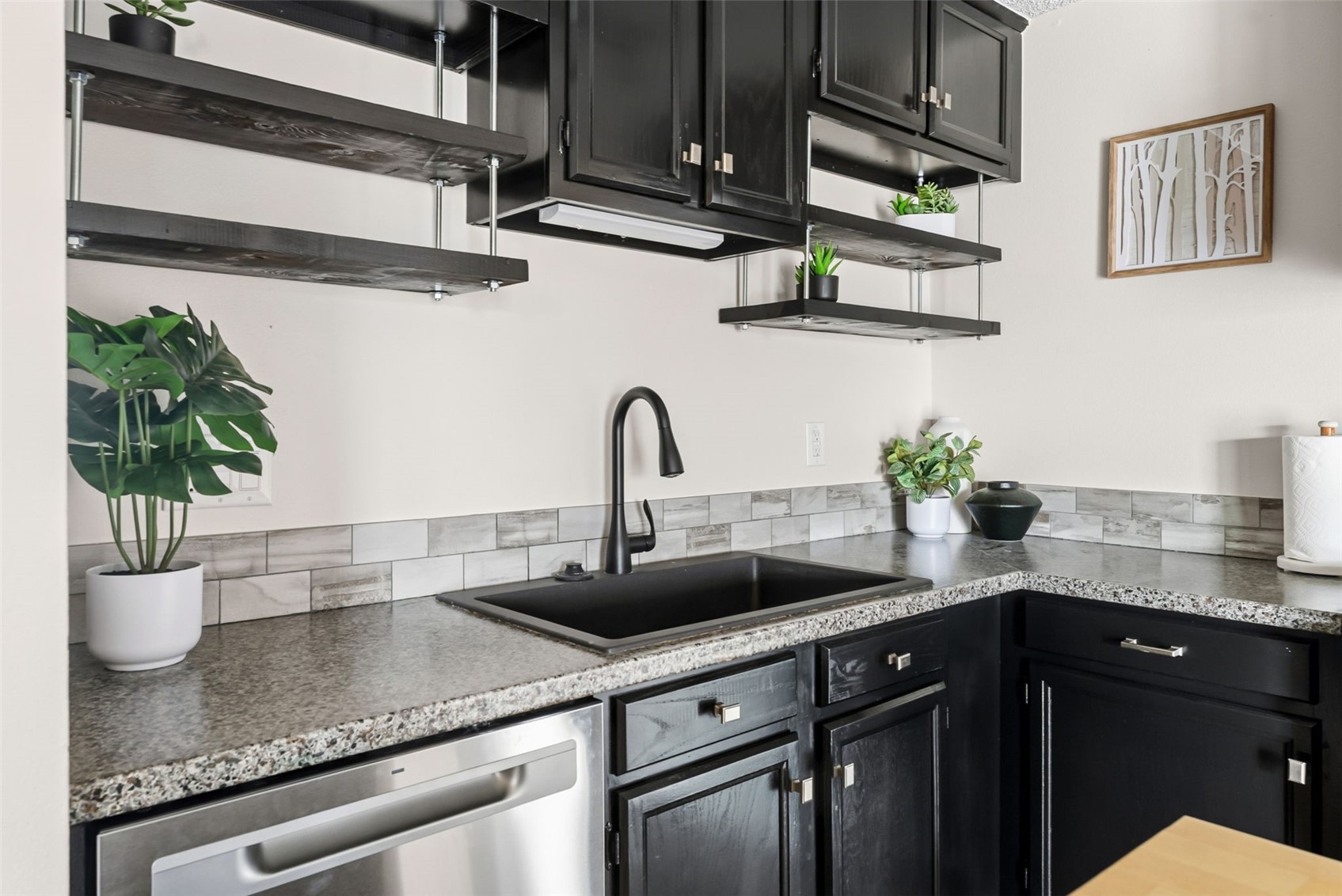 7124 Ryan Gulch Road, Unit 204 Wildernest, CO 80498 - Photo 20 of 36 Kitchen with open shelves, dark cabinetry, stainless steel dishwasher, and dark stone countertops