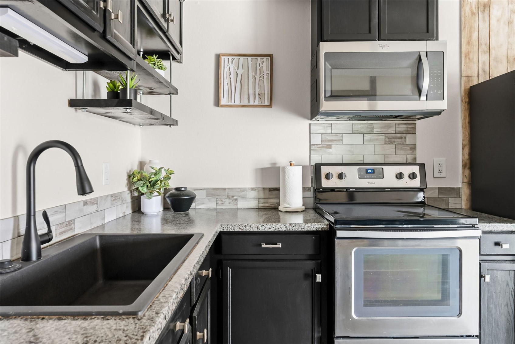 7124 Ryan Gulch Road, Unit 204 Wildernest, CO 80498 - Photo 22 of 36 Kitchen with stainless steel appliances, backsplash, and dark cabinets